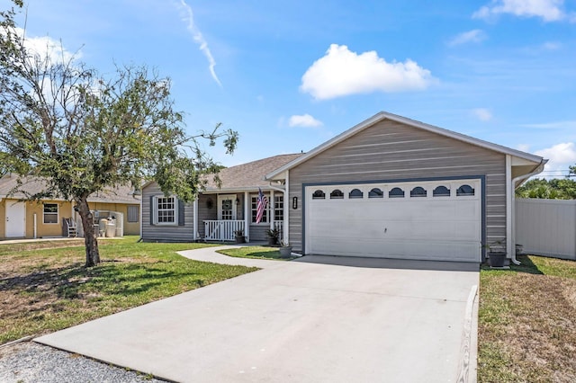 ranch-style house with a porch, a front yard, concrete driveway, and an attached garage