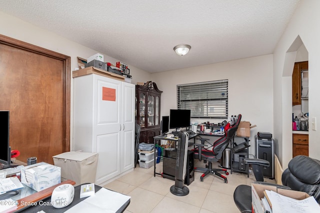 office space featuring tile patterned flooring and a textured ceiling