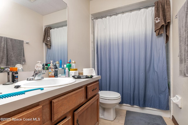 bathroom with shower / bath combination with curtain, tile patterned flooring, vanity, and toilet