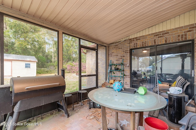 sunroom / solarium with vaulted ceiling and wooden ceiling