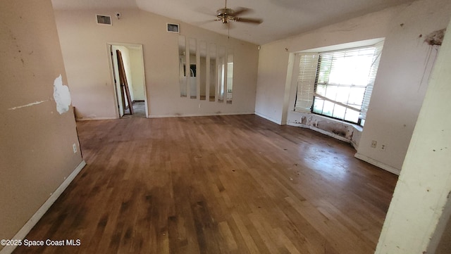 empty room with dark wood-type flooring, visible vents, vaulted ceiling, and ceiling fan