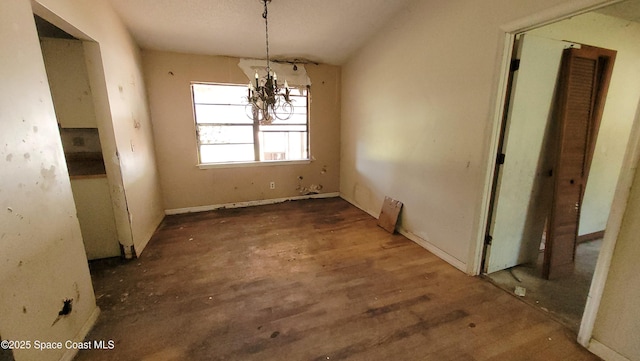 unfurnished dining area featuring a chandelier