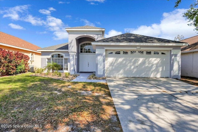 view of front of property with a shingled roof, a front lawn, concrete driveway, stucco siding, and an attached garage