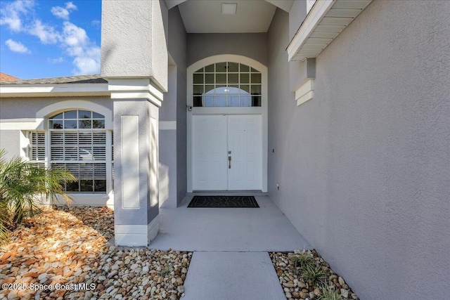 doorway to property with stucco siding