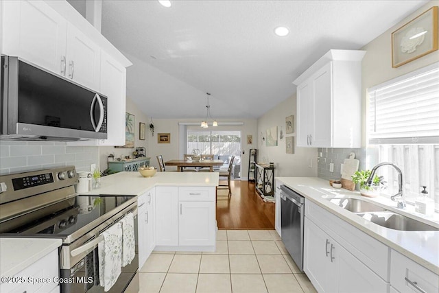 kitchen featuring light tile patterned floors, appliances with stainless steel finishes, light countertops, and a sink