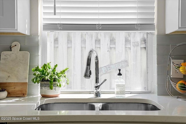 details featuring white cabinetry and a sink