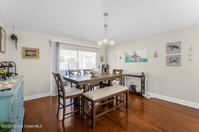 dining room featuring baseboards and dark wood-type flooring