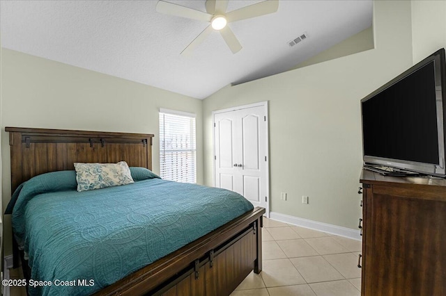 bedroom with visible vents, a ceiling fan, baseboards, light tile patterned floors, and lofted ceiling