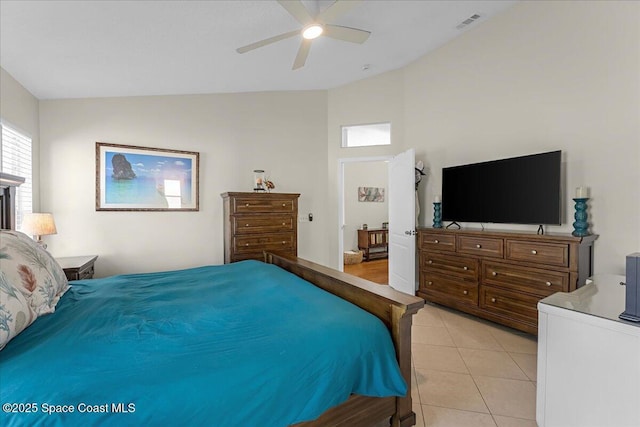 bedroom featuring vaulted ceiling, light tile patterned flooring, visible vents, and ceiling fan