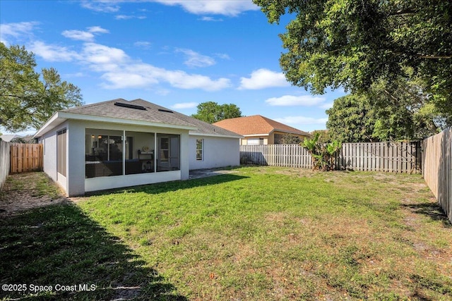 view of yard with a fenced backyard and a sunroom