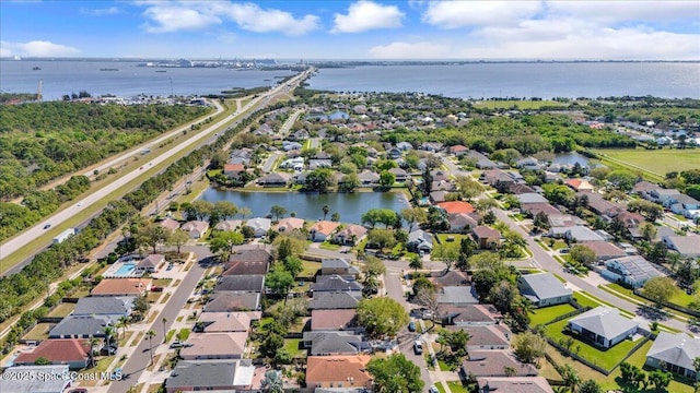 drone / aerial view with a residential view and a water view