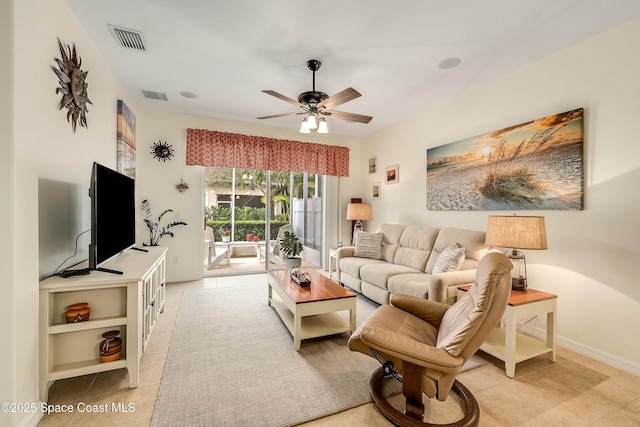 living room with a ceiling fan, visible vents, and light tile patterned flooring