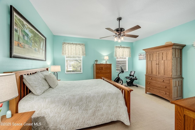 bedroom featuring baseboards, a ceiling fan, and light colored carpet