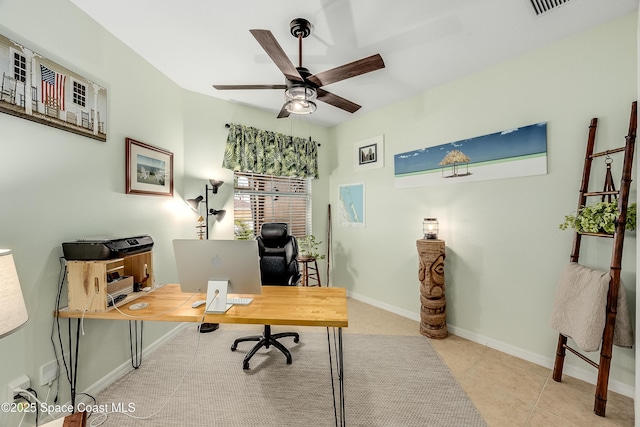 tiled office featuring a ceiling fan and baseboards