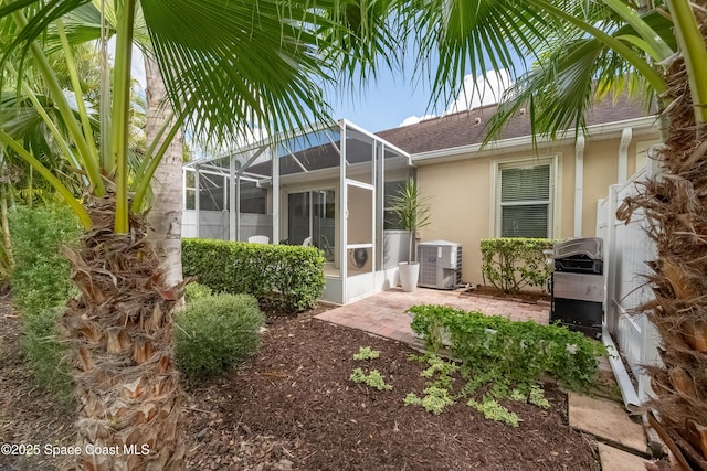 exterior space featuring a patio area, cooling unit, and a lanai