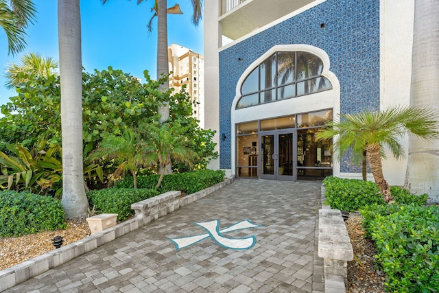 property entrance with french doors and stucco siding