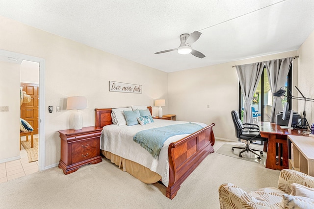 bedroom featuring a textured ceiling, ceiling fan, baseboards, and light colored carpet