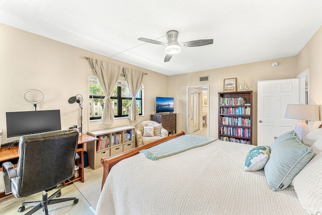 bedroom with light carpet, visible vents, and a ceiling fan