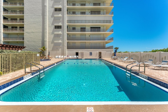 pool featuring a patio area and fence