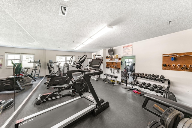 workout area featuring visible vents and a textured ceiling