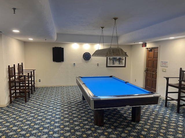 playroom with a textured wall, baseboards, dark colored carpet, and pool table