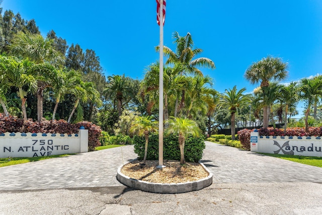 surrounding community featuring decorative driveway