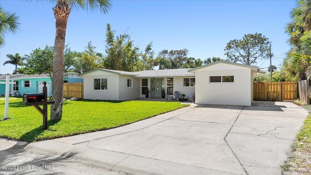 ranch-style home featuring a front lawn, fence, and stucco siding