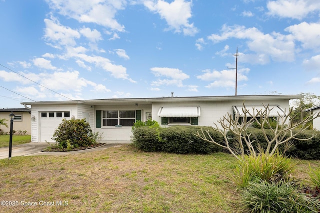 ranch-style house featuring a front lawn, driveway, and an attached garage