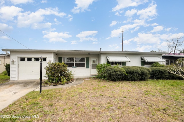 ranch-style home with a garage, a front yard, and driveway