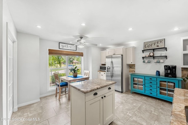 kitchen with white cabinets, a ceiling fan, recessed lighting, light stone countertops, and stainless steel appliances