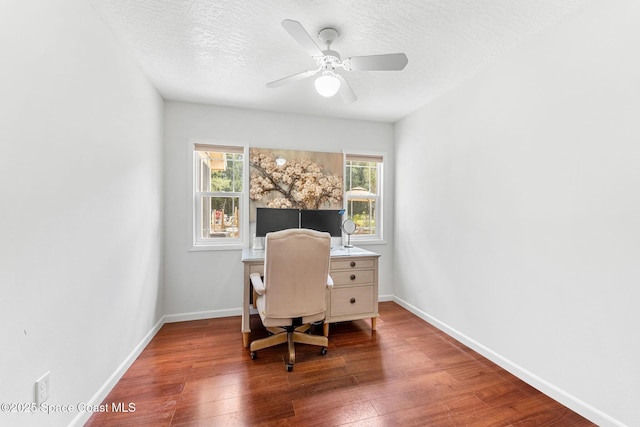 office featuring baseboards, ceiling fan, hardwood / wood-style floors, and a textured ceiling
