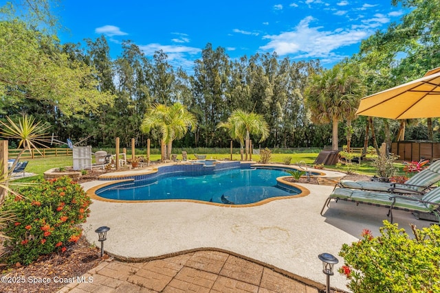 pool with a jacuzzi, fence, and a patio