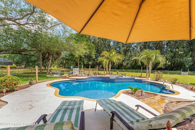 view of swimming pool featuring a yard, a patio area, a fenced backyard, and a pool with connected hot tub