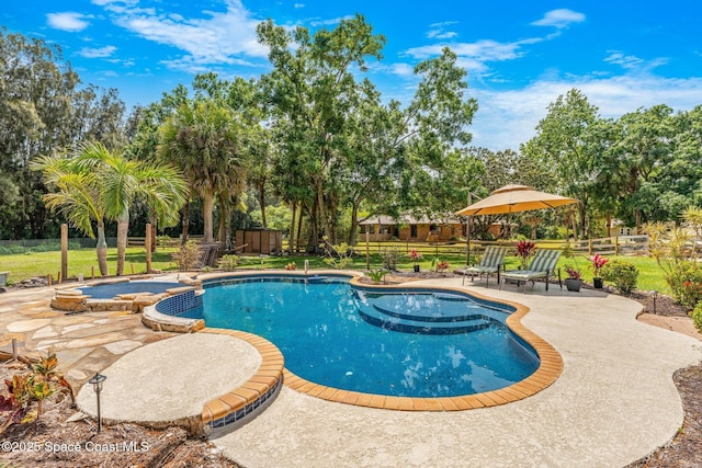 view of pool featuring a yard, a patio area, a fenced backyard, and a pool with connected hot tub