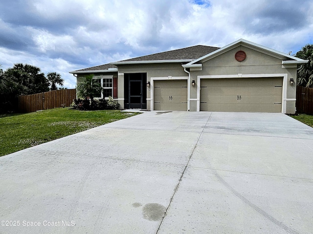 view of front of house featuring a garage, fence, driveway, stucco siding, and a front yard