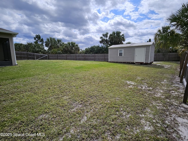 view of yard with an outbuilding, a storage shed, and a fenced backyard