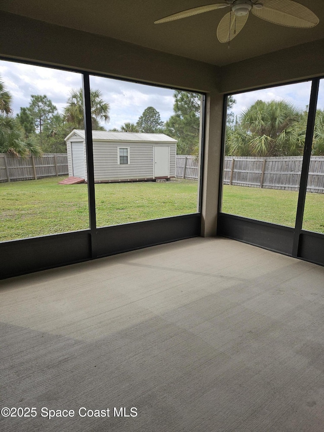 unfurnished sunroom with ceiling fan and a wealth of natural light