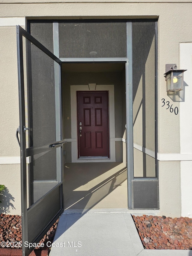 doorway to property with stucco siding