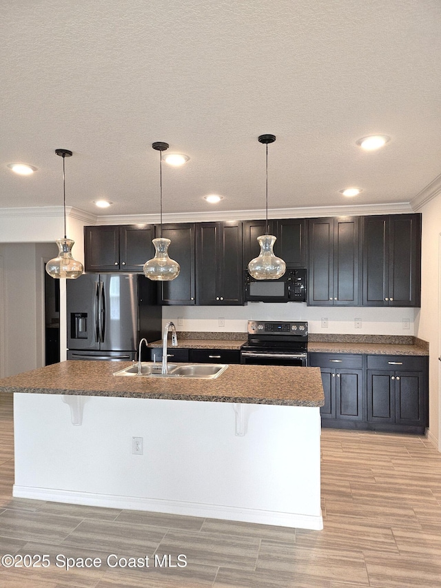 kitchen with pendant lighting, black microwave, electric range, and stainless steel fridge with ice dispenser