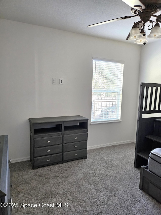 bedroom featuring dark carpet, baseboards, and ceiling fan