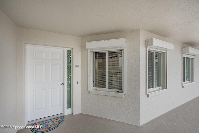 view of exterior entry featuring stucco siding