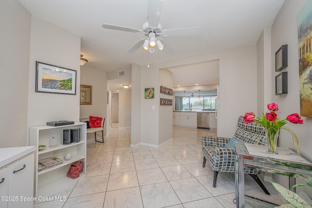 interior space with visible vents, ceiling fan, and baseboards