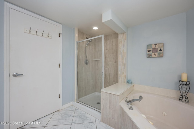 bathroom with a stall shower, marble finish floor, and a garden tub