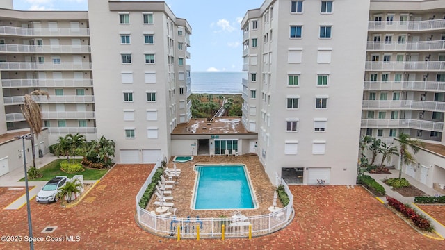 view of pool featuring a water view