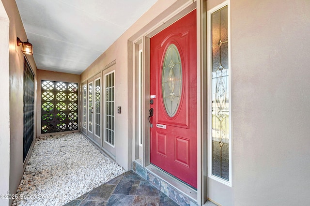 property entrance with stucco siding