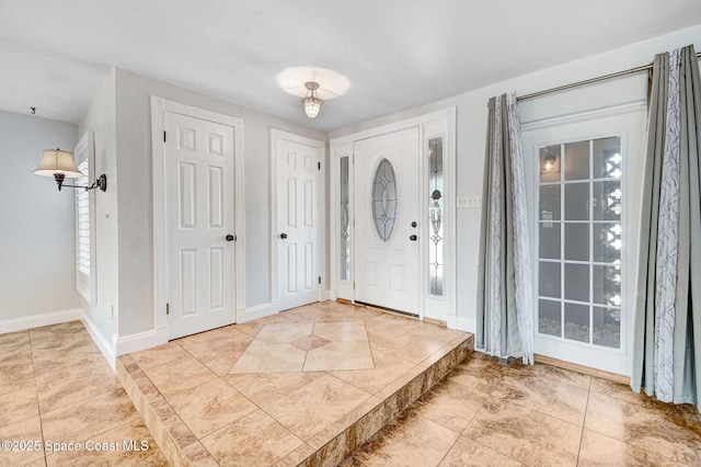 foyer featuring baseboards