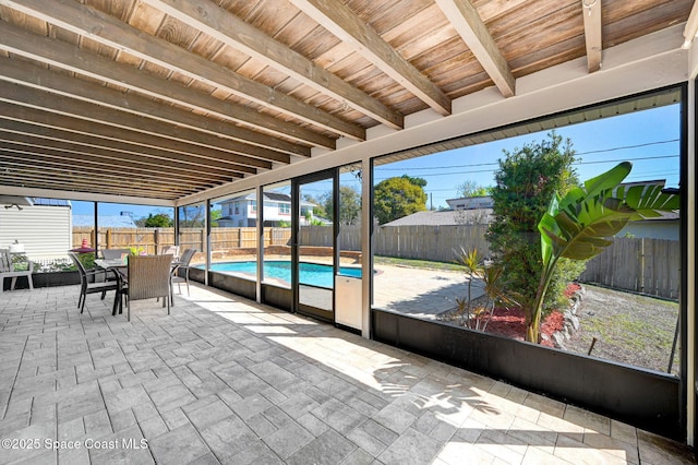 unfurnished sunroom featuring wooden ceiling and beam ceiling