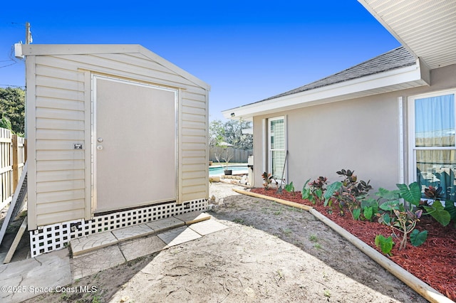 view of shed with fence