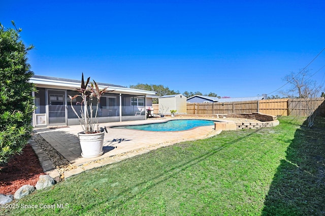 view of swimming pool featuring a sunroom, a fenced backyard, a yard, and a patio