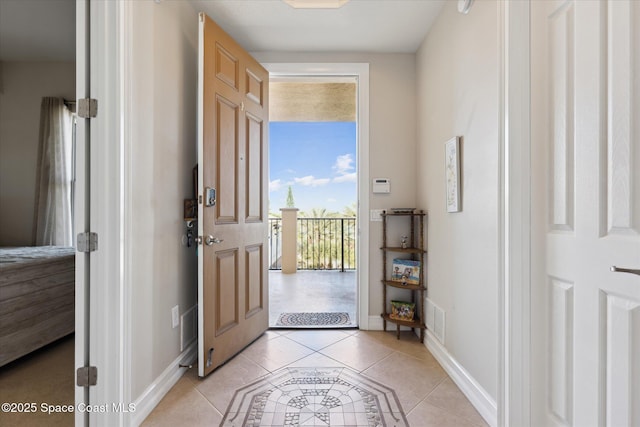 interior space with light tile patterned floors, visible vents, and baseboards